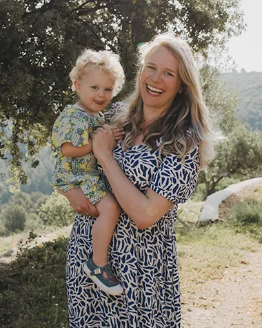 happy mum holding toddler on holiday at farmstay alicante caserio del mirador