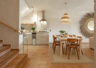 Carrasca family apartment has an open plan kitchenette and dining area, stairs lead up to the 2 bedrooms