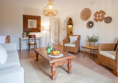 Vinya baby-friendly apartment has a spacious lounge with desk and space for a cot. Walk through the arch to find a kithenette and dining area